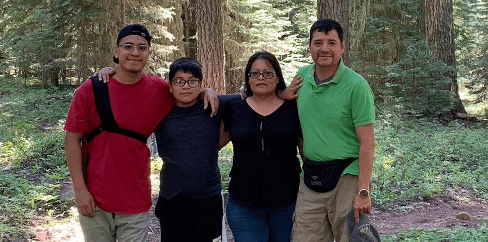 Hemophilia A patient, Daniel Cruz with his family Hemophilia A Patient, Daniel Cruz, smiling with his family outside in nature